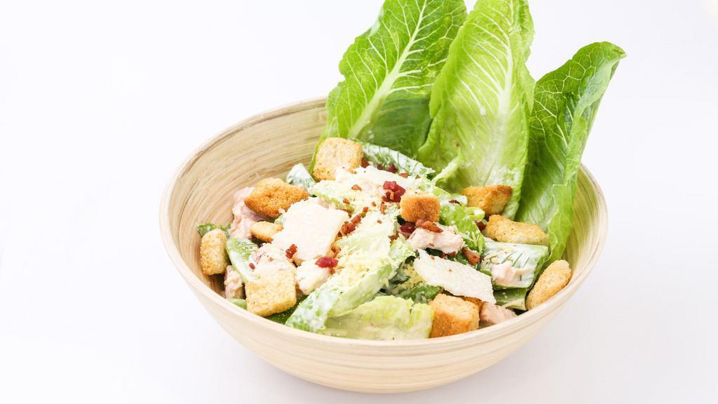 Grilled Chicken Caesar Salad · Fresh green salad prepared with Grilled chicken, cheese, romaine lettuce, carrots, grape tomatoes, and caesar dressing.