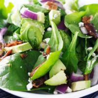 Baby Spinach Salad · Fresh garden salad prepared with Baby spinach, red onions, cucumber, and green apples in a h...
