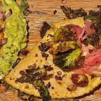 Bruselas Quesadilla · Shaved Brussels Sprouts, Mushroom, Sauteed Onion, Oaxaca Cheese, Topped With Homemade Guacam...