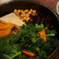 Ginger Root Macro Bowl · Steamed pumpkin, chickpeas, kale, black seaweed, broccoli, carrot, and tofu on a bed of brow...