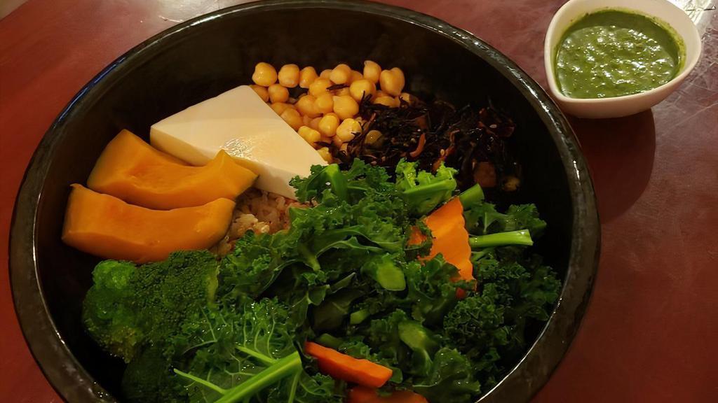 Ginger Root Macro Bowl · Steamed pumpkin, chickpeas, kale, black seaweed, broccoli, carrot, and tofu on a bed of brown rice.