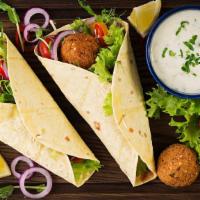 Israeli Falafel Pita Sandwich · Delicious sandwich made with Falafel, fried Eggplant, vegetables, pickles, Hummus, Tahini, a...