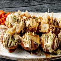 Takoyaki · Wheat flour-based batter filled with minced octopus and topped with green laver, bonito flak...