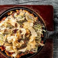 Okonomiyaki · Japanese pancake filled with grated yam, cabbage, corn and topped with green laver, bonito f...