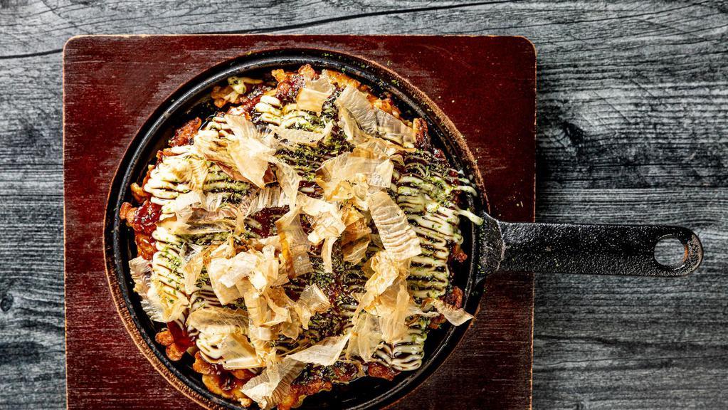 Okonomiyaki · Japanese pancake filled with grated yam, cabbage, corn and topped with green laver, bonito flakes, okonomiyaki sauce & Japanese mayo.