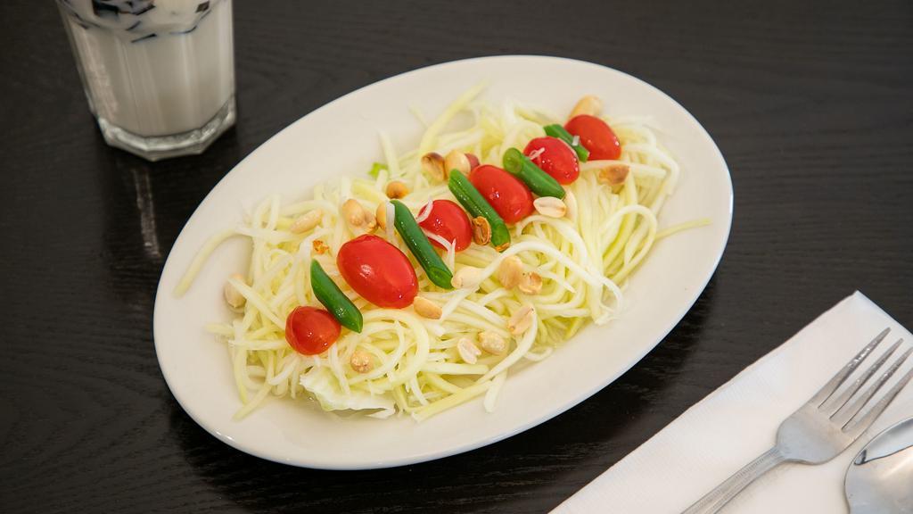 Thai Papaya Salad · Spicy. Strings of pickled raw papaya and tomatoes topped with crushed peanut.