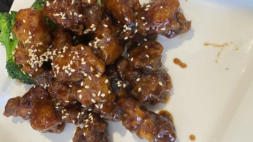 Sesame Chicken · Deep fried sliced chicken with sesame seeds and brown sweet and sour sauce.