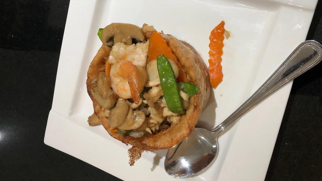 Sarang Burong · Shaped fried taro stuffed with shrimp, chicken, corn, snow peas and black mushroom topped with cashew nuts.