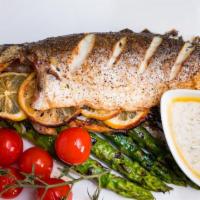 Branzino · grilled whole fish. mashed potato, choice of grilled asparagus or steamed broccoli. lemon ga...