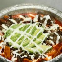 Chilaquiles De Carne Asada · Chilaquiles with grilled steak then topped with sour cream, cotija cheese, onions, and avoca...