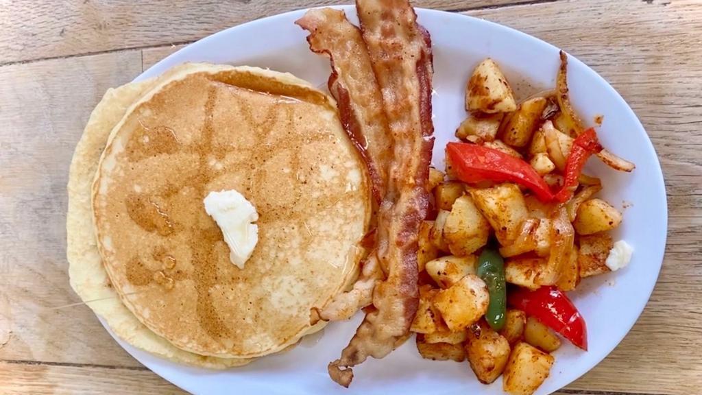 Buttermilk Pancakes · Three delicious buttermilk pancakes served with syrup, butter, and grape jelly. Served with bacon, sausage or turkey bacon