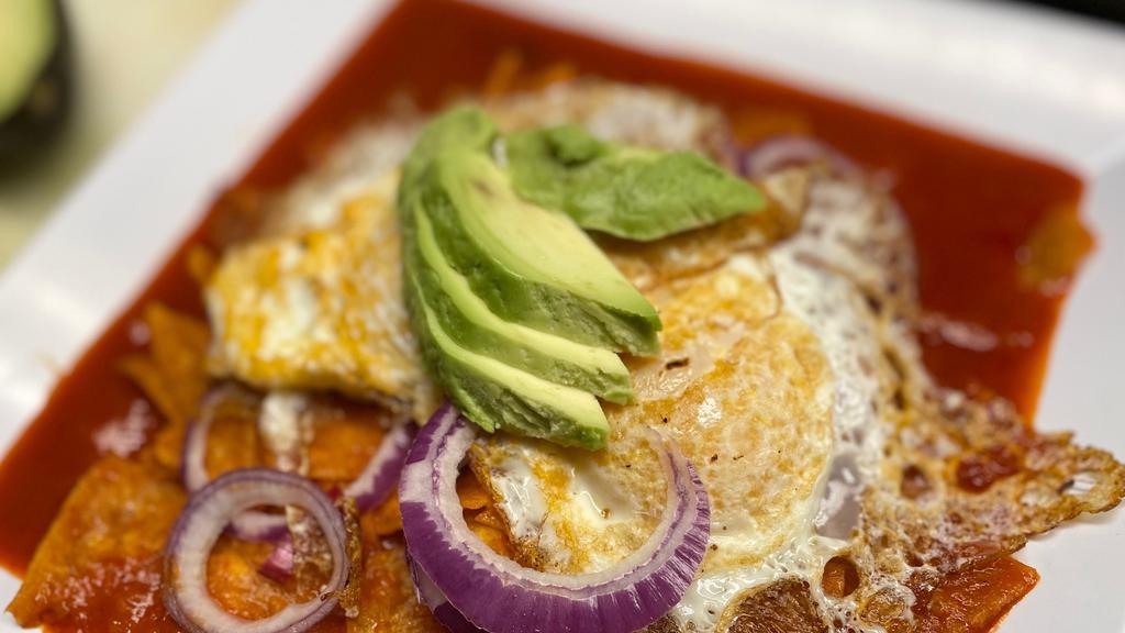 Chilaquiles De Pollo · Chilaquiles with shredded chicken then topped with sour cream, cotija cheese, onions, and avocado.