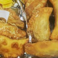 Traditional Puerto Rican Beef Empanadas · Ground beef,,  prepared with homemade sofrito and olive oil with chimichurri sauce.