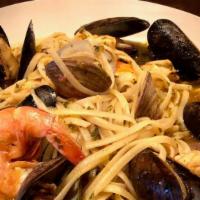 Seafood Pasta · Shrimp, Mussels, Clams, Salmon over Linguine, Garlic, Spices, Wine, Touch of Tomato Sauce