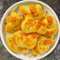 Garlic Knot The Knot · Savory bite sized tender dough twists slathered in garlic olive oil and baked golden brown w...