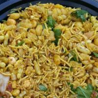 Minakshi’S Bhelpuri · Savory puffed rice with crispy chickpea noodles, fresh onions, cilantro, mint chutney and sw...