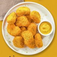 Chicken Nuggets · Bite sized nuggets of chicken breaded and fried until golden brown. (8 pieces)