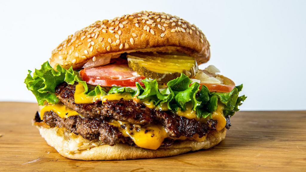 Double Cheeseburger · Two 1/4 Pound Premium Beef, American Cheese, Lettuce, Chopped Onions, Tomatoes, Sweet Pickles, and House Sauce on a Toasted Sesame Bun.