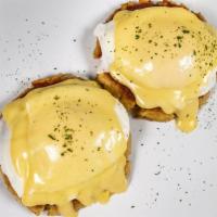 Crab Cake Benedict · Authentic Maryland crab cakes topped with poached eggs and Hollandaise sauce, served with se...