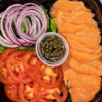 Smoked Salmon Plate · 8 pieces of smoked salmon, 8 slices of tomato, 16 red onion rings, 1 oz of capers, along wit...