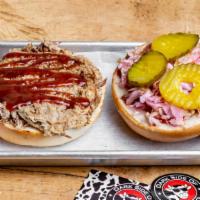 Pulled Pork Sandwich · Hickory smoked for 12 hours. Featuring house made bbq sauce, coleslaw and pickles.