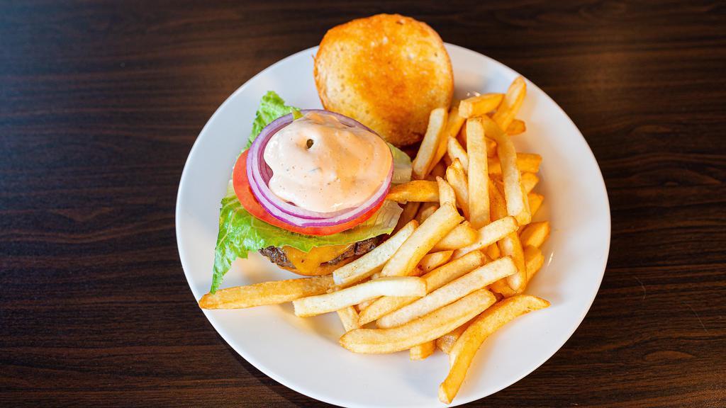 The Standard Cheeseburger · 6 oz all beef patty, lettuce, tomato, red onions, pickles, cheddar cheese & secret sauce.