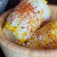 Corn On The Cob · Topped with mayonnaise, tajin, lime and cotija cheese.