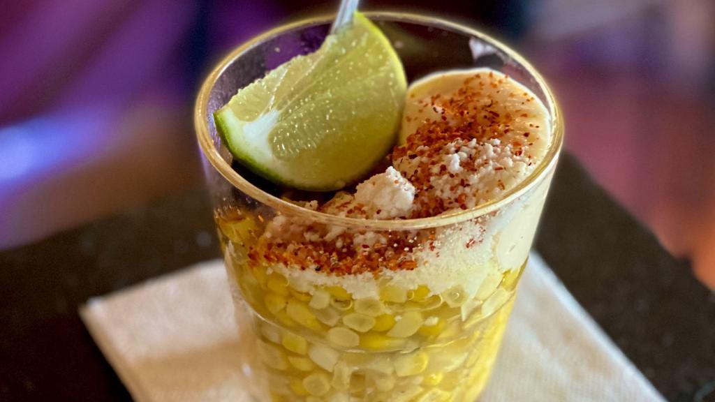 Traditional Esquites · Corn kernels with mayo, lime juice, tajin & cotija cheese. Served in a cup.