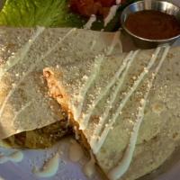 Quesadilla · Served on a flour tortilla filled with mixed cheeses, topped with sour cream &  cotija chees...
