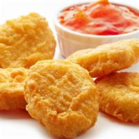 Chicken Nuggets (6) · Chicken nuggets served with fried potatoes.