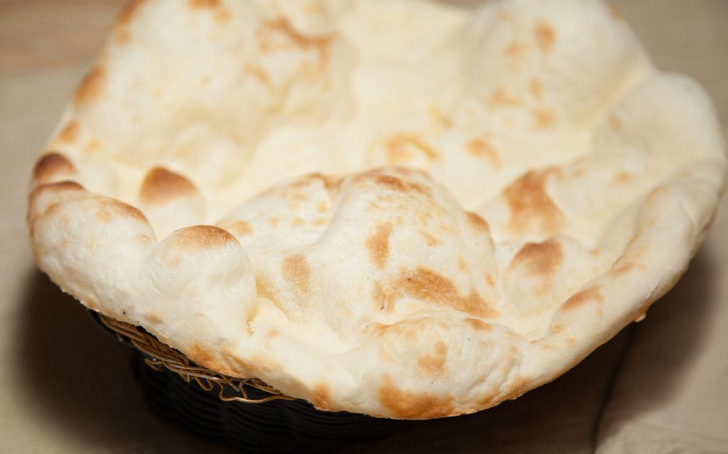 Plain Naan · Unleavened bread freshly baked in a clay oven.