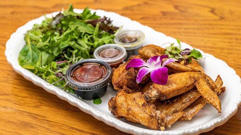 Adama'S Wings · Gluten free, medium. Seasoned baked and fried chicken wings served with mixed green salad, Azara spicy BBQ sauce on the side.