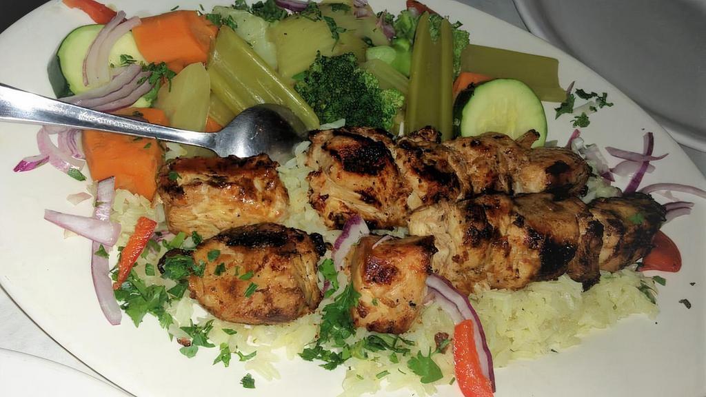 Chicken Kebob · Char grilled marinated chunks of boneless chicken breast served with house rice steamed fresh mixed vegetables and salad. served with pita bread and salad.