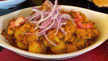 Aloo Gobhi · Potatoes and cauliflower sauteed with onions and tomatoes cooked with traditional spices.