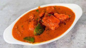 Chicken Tikka Masala · Chunks of chicken cooked in a light creamy tomato sauce with bell peppers and onions.
