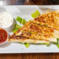 Wicked Quesadilla · Cheddar-Jack Cheese, caramelized onions, peppers topped with  sour cream and chili bbq sauce