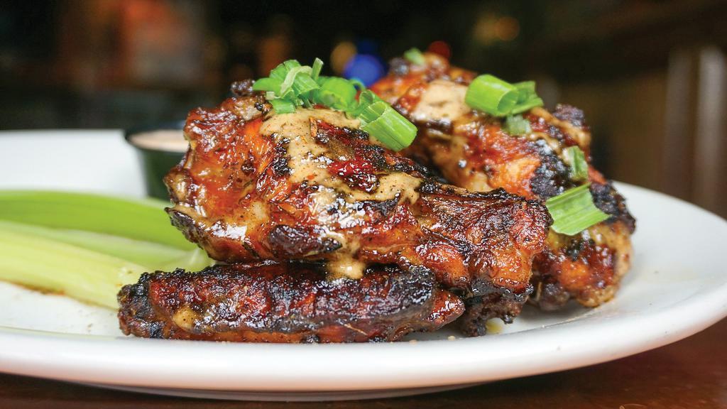 Grilled Jamaican Wings · Jumbo wings tossed in our homemade spicy jerk sauce. Served with celery sticks and Santa Fe ranch dressing.