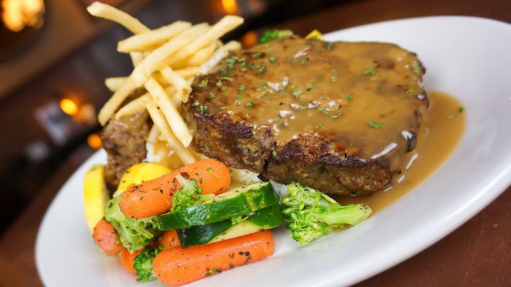Meatloaf Dinner · Our own recipe of ground sirloin, onions, mushrooms and seasonings served over mashed potatoes then smothered with gravy. Served with seasonal veggies. (Starts at 4:30 pm)