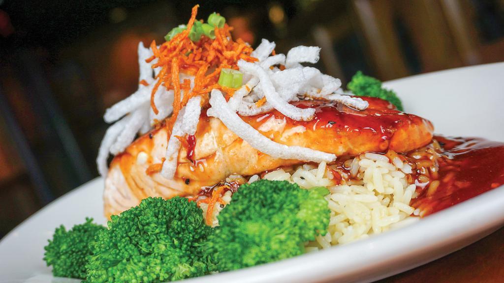 Hibachi Salmon · Norwegian salmon brushed with a teriyaki Asian glaze and topped with fried carrots, rice noodles, scallions and sesame needs. Served with steamed broccoli and seasoned rice.
