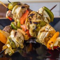 Chicken Or Lamb Kebab · 3 skewers grilled cubes of meat with pickles, garlic sauce, lettuce and tomatoes.