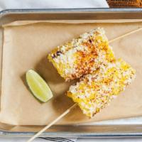 Mexican Street Corn · Grilled corn with mayo, paprika, and Cotija cheese.