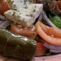 Greek Salad · Lettuce, tomatoes, onions, peppers, Greek olives, cucumbers, anchovies and stuffed grape lea...