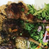 Rosemary Lamb Chop Lollipops · Served with yellow rice and a freshly tossed green salad