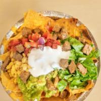 Chicken Nachos · Served with pinto beans, salsa, melted cheese, lettuce, pico de gallo, sour cream, and guaca...