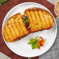 Bacon Chomp Panini · Breaded chicken cutlet, cheddar cheese, bacon, mixed greens, tomato, and ranch dressing on t...