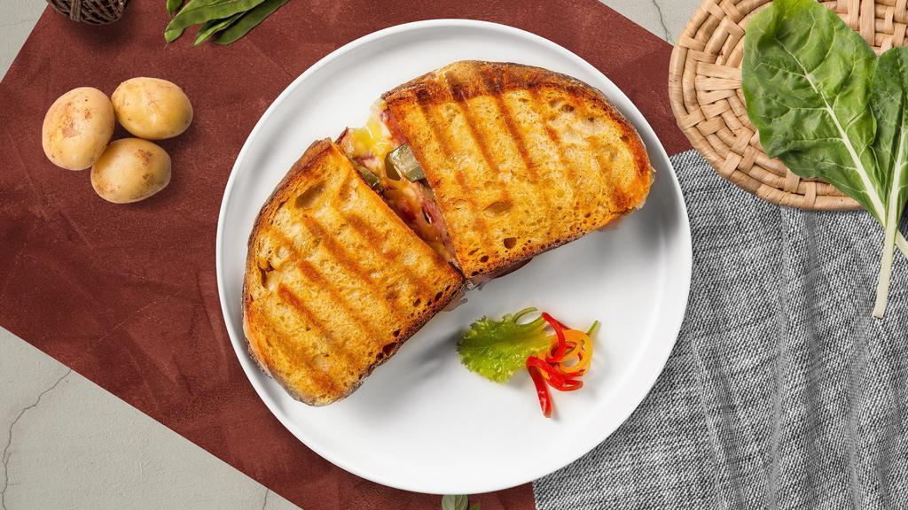 Monte Cheesy Panini · Turkey ham, turkey, Swiss cheese, cheddar cheese, lettuce, tomato, and honey mustard on toasted bread.