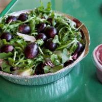 Arugula Salad · Arugula, baby greens, dried cranberries, almonds, feta cheese. Topped with tomatoes in a hou...