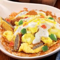 Country Fried Steak Skillet · Sliced country fried steak atop scrambled eggs with diced onion and peppers over a bed of se...