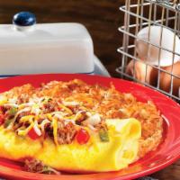 Kitchen Sink Omelette · Bacon, sausage, onion, green pepper, tomatoes, four-cheese blend, and hash browns all inside...