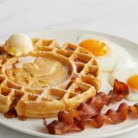 Waffle Eggs And Bacon · A Belgian waffle dusted with powdered sugar, alongside two eggs any style and two strips of ...